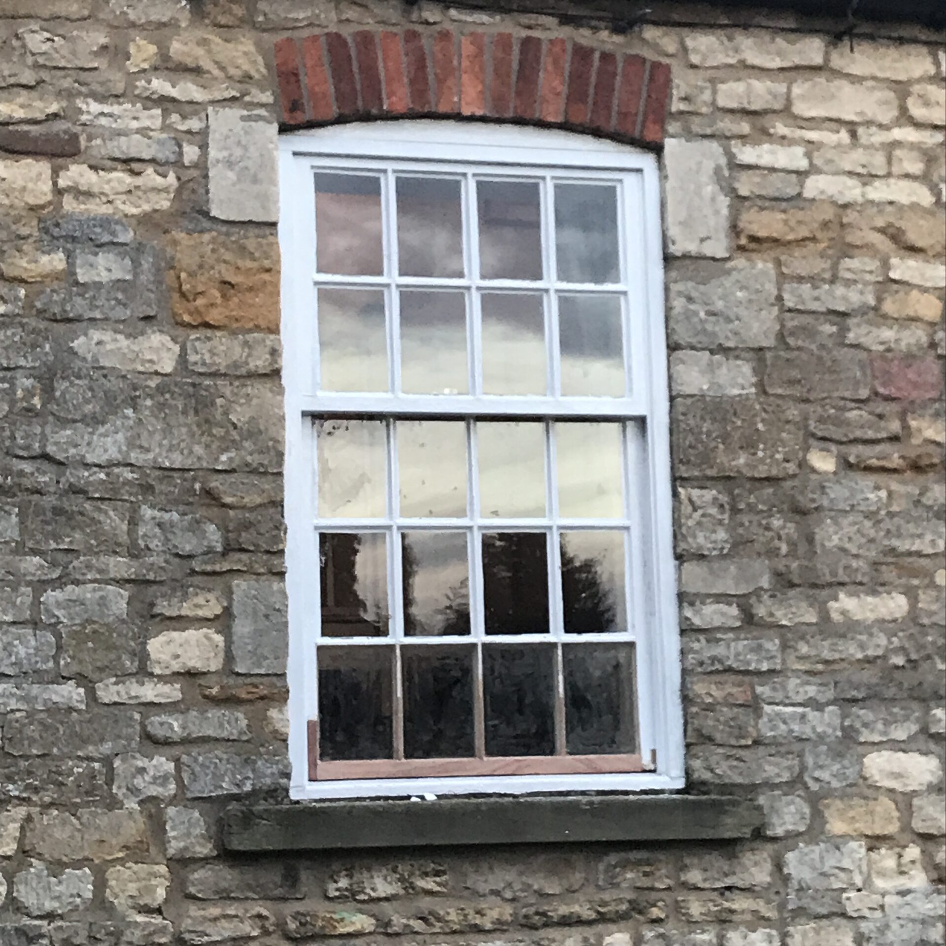 Sash window fitted in a stone listed building